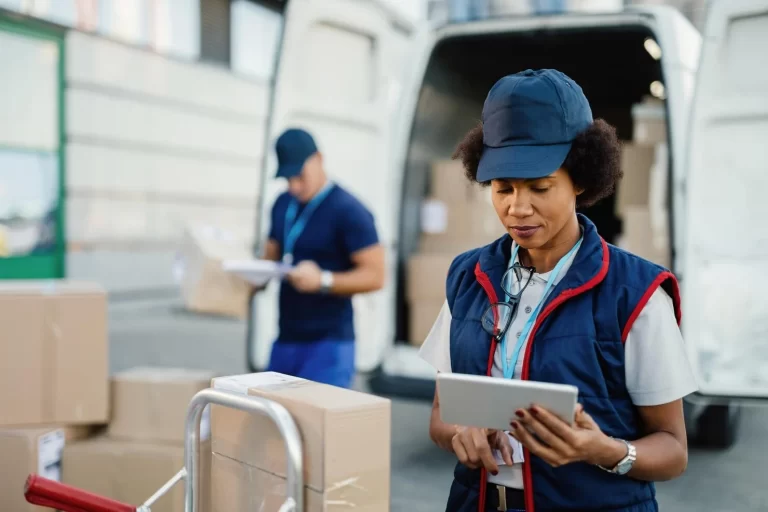 african-american-female-worker-making-inventory-packages-organizing-delivery-schedule-digital-tablet-her-colleague-is-working-background_637285-2227